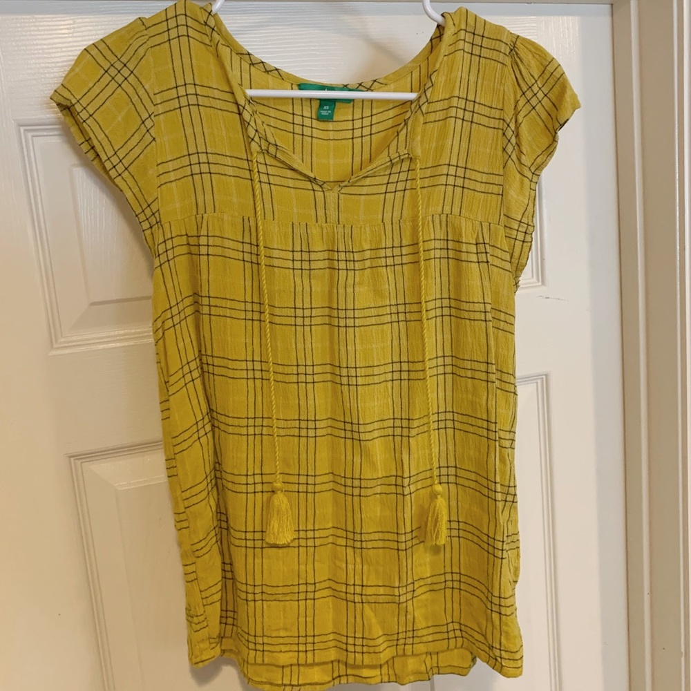 Yellow shirt with black stripes and fun tassels in the front